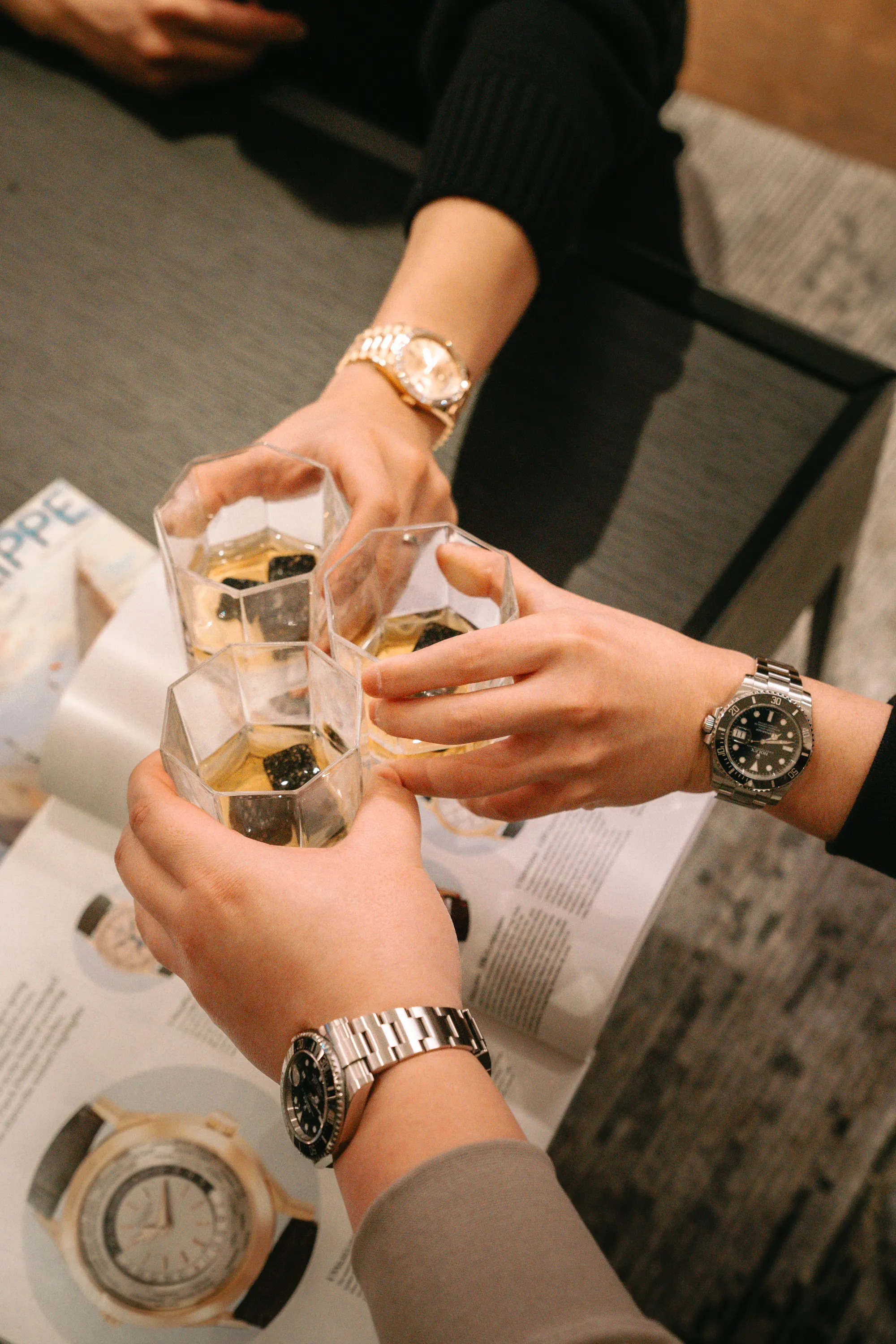 A luxury watch presented in a dark, editorial setting
